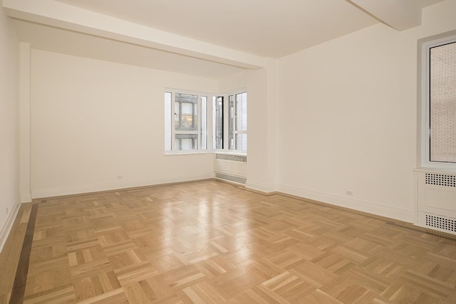 empty room with baseboards and radiator heating unit