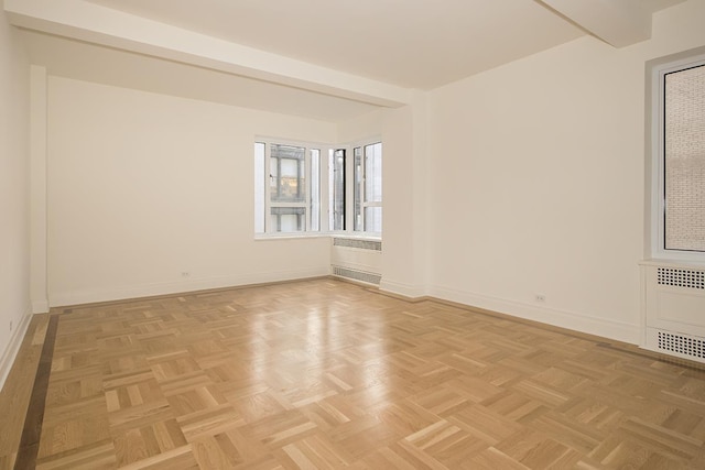 spare room with baseboards