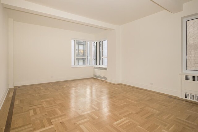 20 E 35th St Unit 8-K, New York City, NY 10016 - spare room featuring baseboards, a wall unit AC, and radiator