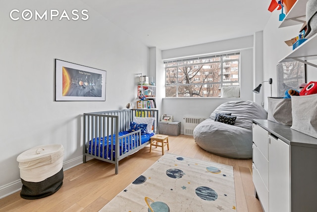 2727 Palisade Ave Unit 3H, New York City, NY 10463 - bedroom featuring radiator heating unit and wood finished floors