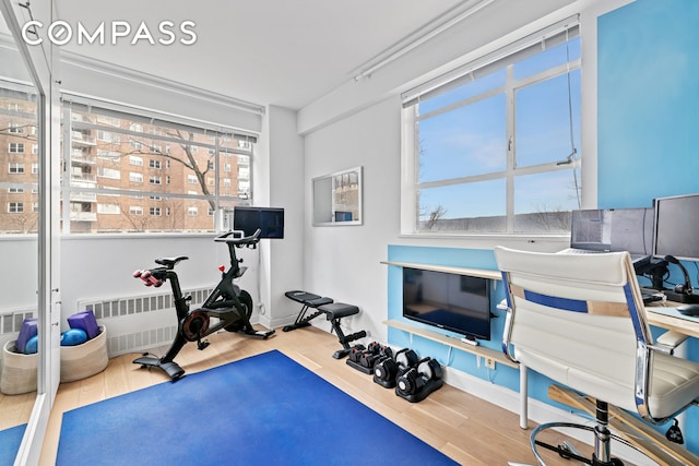 2727 Palisade Ave Unit 3H, New York City, NY 10463 - workout room with wood finished floors and radiator heating unit