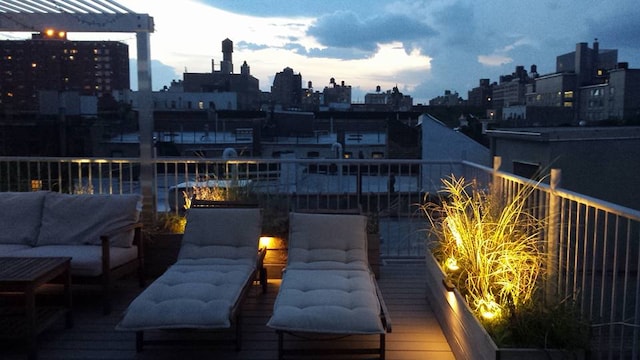 view of patio with an outdoor hangout area, a city view, and a balcony