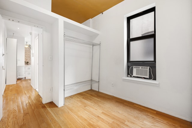 spacious closet featuring light wood finished floors and cooling unit