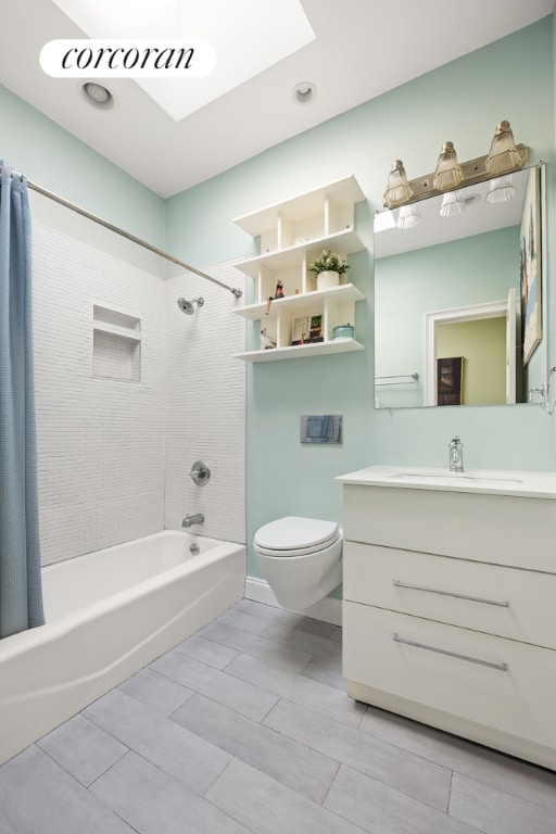 full bathroom with shower / tub combo with curtain, vanity, and toilet