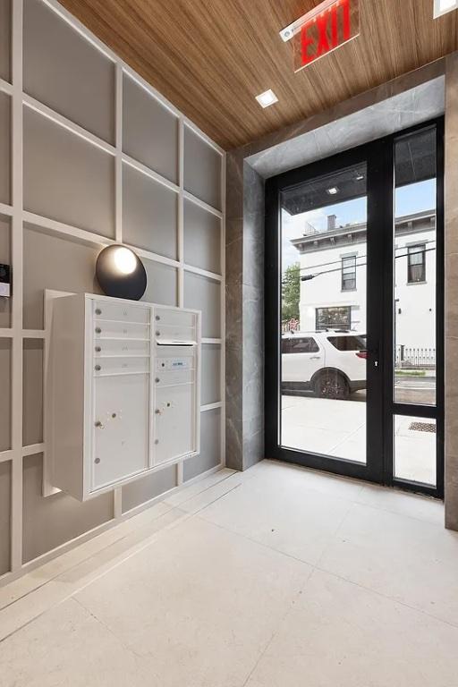 interior space featuring plenty of natural light, wooden ceiling, and mail boxes