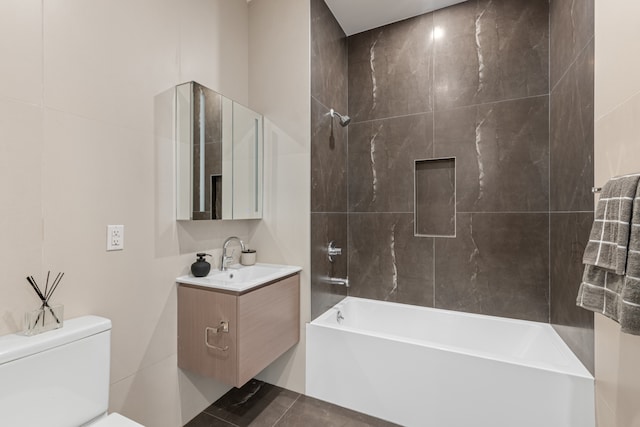 full bathroom featuring toilet, washtub / shower combination, and vanity