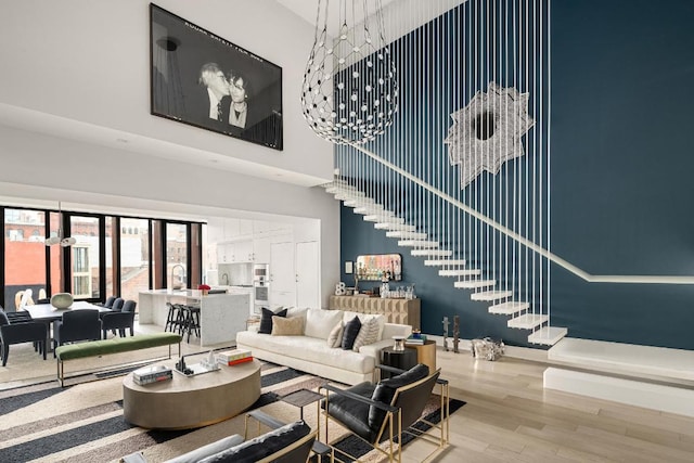 living room with hardwood / wood-style floors and a high ceiling