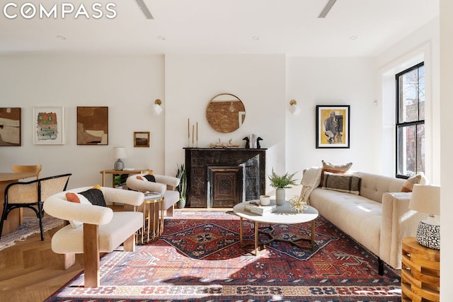 living room featuring parquet flooring and a premium fireplace