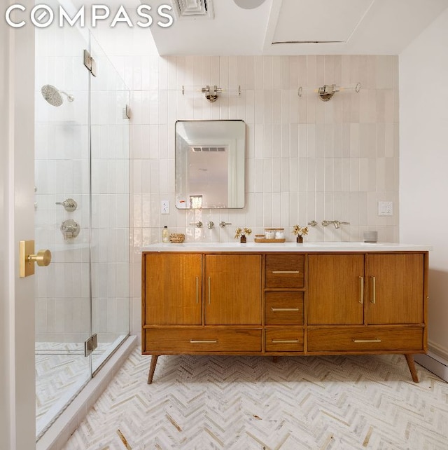 bathroom with tile walls, an enclosed shower, and vanity