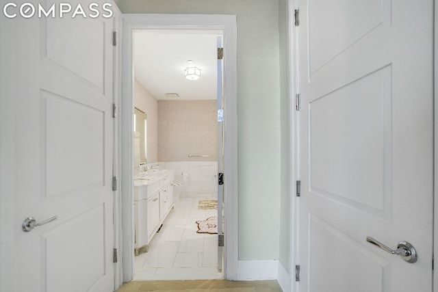 corridor featuring light tile patterned floors