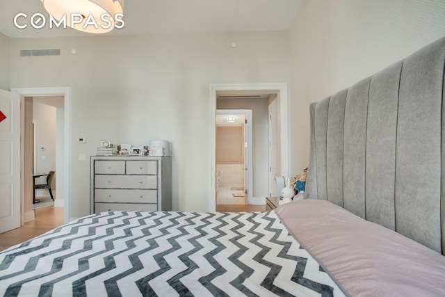 bedroom with visible vents and connected bathroom