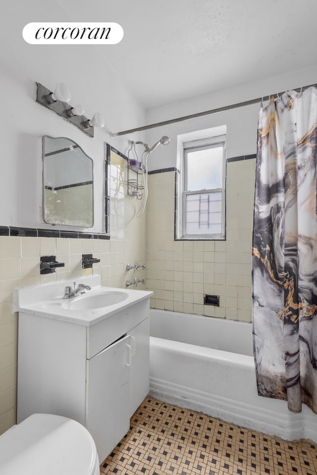 full bathroom featuring vanity, toilet, shower / bath combination with curtain, and tile walls