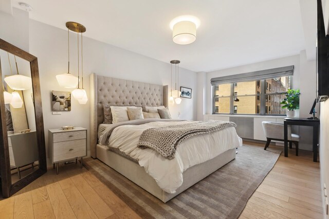 bedroom with hardwood / wood-style floors