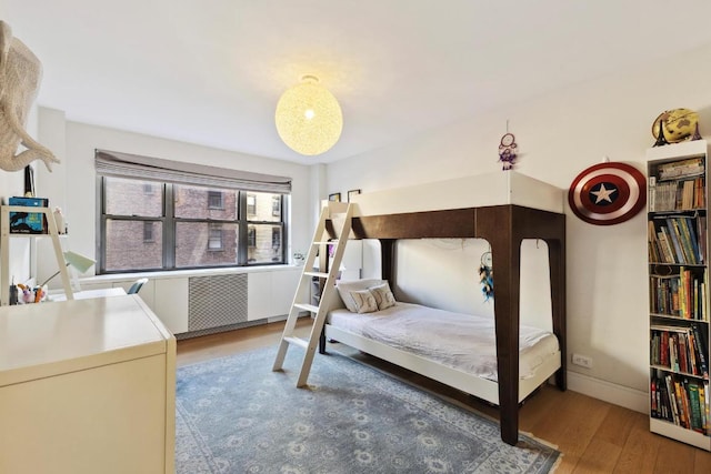 bedroom with hardwood / wood-style flooring