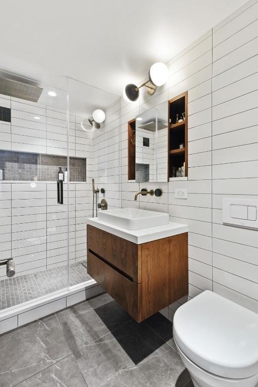 bathroom with vanity, toilet, and an enclosed shower