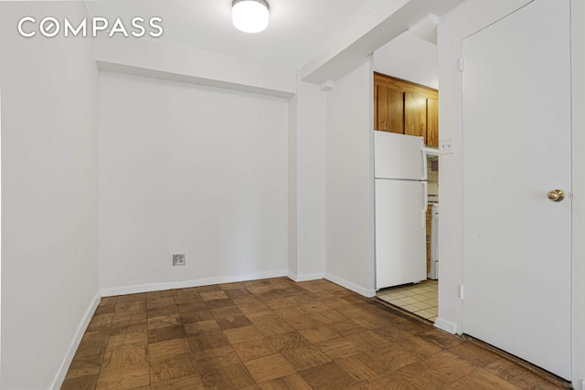 spare room featuring baseboards
