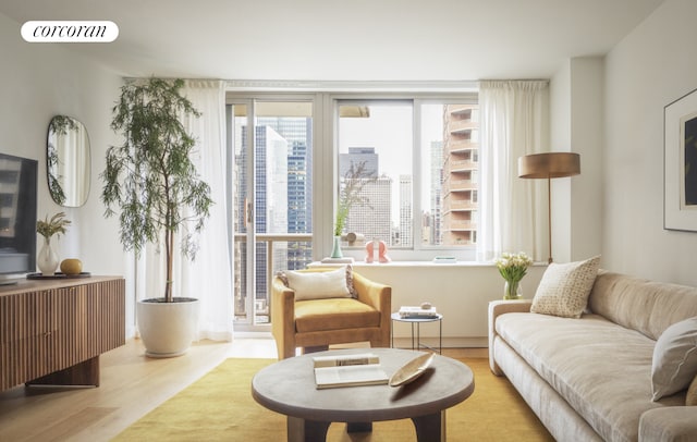 living area with visible vents, a city view, and wood finished floors