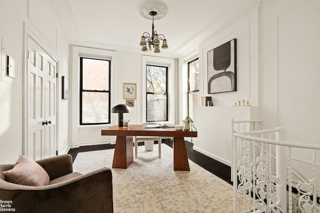 office space featuring ornamental molding, an inviting chandelier, and dark hardwood / wood-style flooring