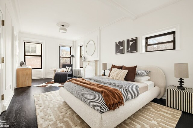 bedroom featuring radiator heating unit, ornamental molding, and dark hardwood / wood-style floors