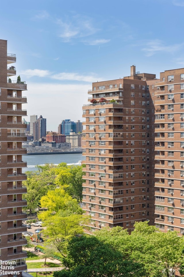 view of property featuring a city view and a water view