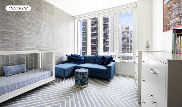 living room featuring baseboards, a city view, and carpet flooring