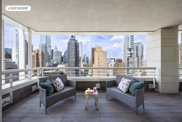 sunroom featuring a healthy amount of sunlight, a view of city, and visible vents