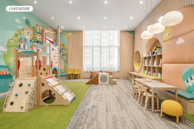 recreation room featuring carpet and built in shelves