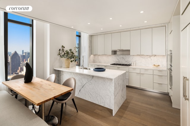 430 E 58th St Unit 55A, New York City, NY 10022 - kitchen featuring tasteful backsplash, visible vents, gas cooktop, and dark wood-type flooring