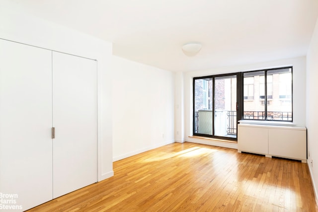 unfurnished bedroom featuring a closet and light hardwood / wood-style flooring