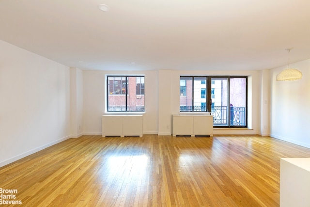 empty room with light hardwood / wood-style flooring