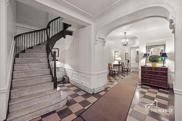 foyer with a chandelier