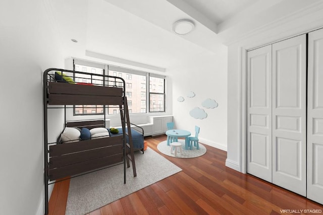 bedroom with a closet and dark hardwood / wood-style floors