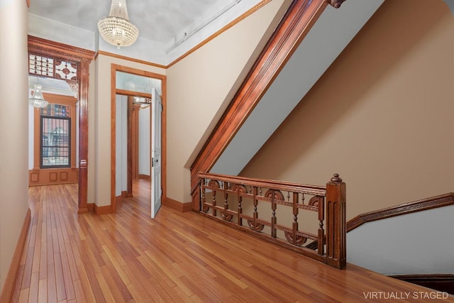 hall featuring an inviting chandelier and light hardwood / wood-style floors