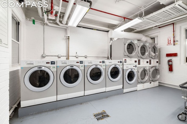 laundry area featuring stacked washer / drying machine and washing machine and clothes dryer