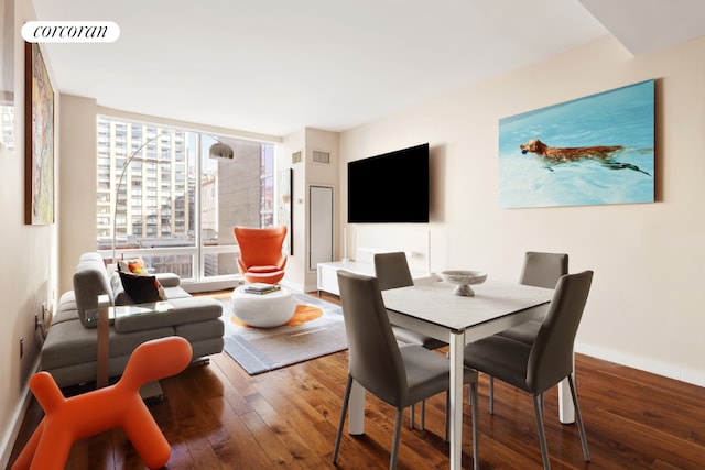 dining area with floor to ceiling windows and hardwood / wood-style floors