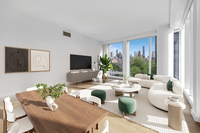 living room featuring floor to ceiling windows and light wood-type flooring