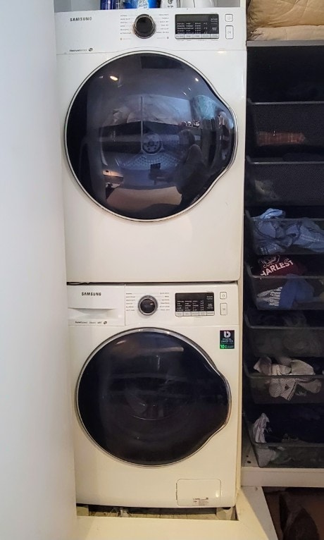 laundry room featuring laundry area and stacked washer / dryer