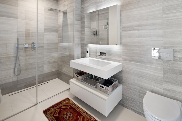 full bath with toilet, a stall shower, tile walls, and tile patterned floors