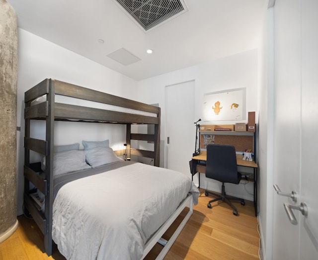 bedroom featuring visible vents, wood finished floors, and recessed lighting