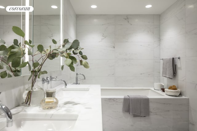 bathroom with vanity and tile walls