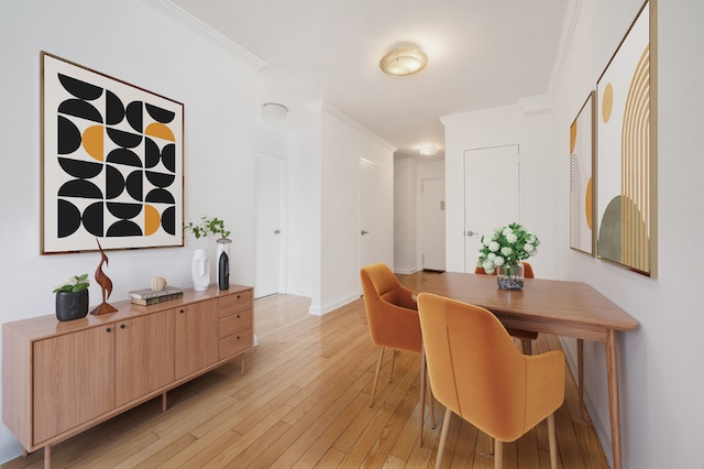 dining area with crown molding and light hardwood / wood-style flooring