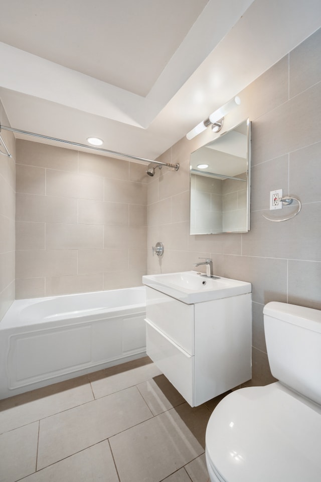 122 Ashland Pl Unit 3D, New York City, NY 11201 - full bathroom with toilet, tile walls, vanity, washtub / shower combination, and tile patterned flooring