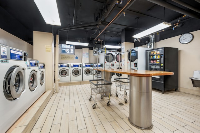 clothes washing area with stacked washer and dryer and separate washer and dryer