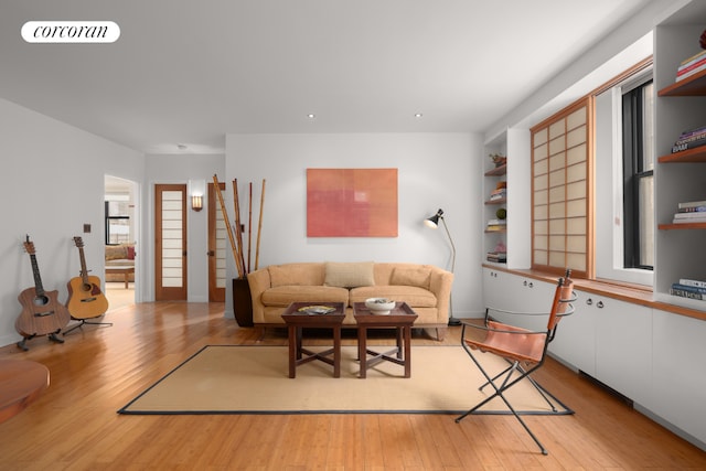 living room featuring a healthy amount of sunlight and light hardwood / wood-style flooring