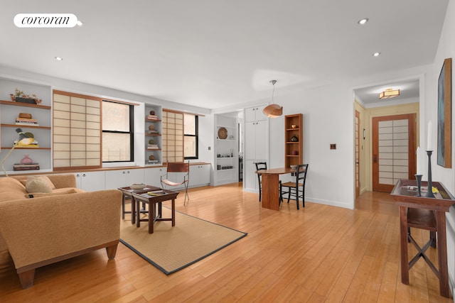 living room featuring visible vents, light wood-style flooring, and recessed lighting