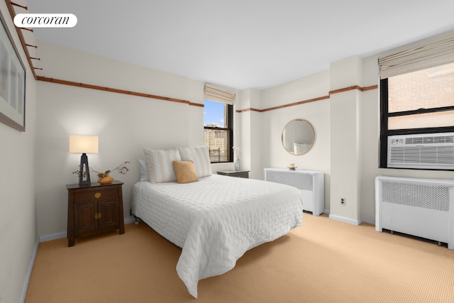 bedroom featuring cooling unit, light colored carpet, and radiator heating unit