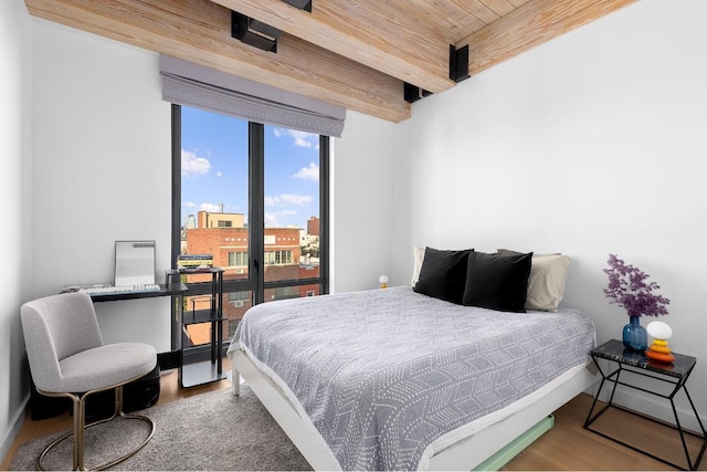 bedroom with wood ceiling, hardwood / wood-style flooring, and beamed ceiling