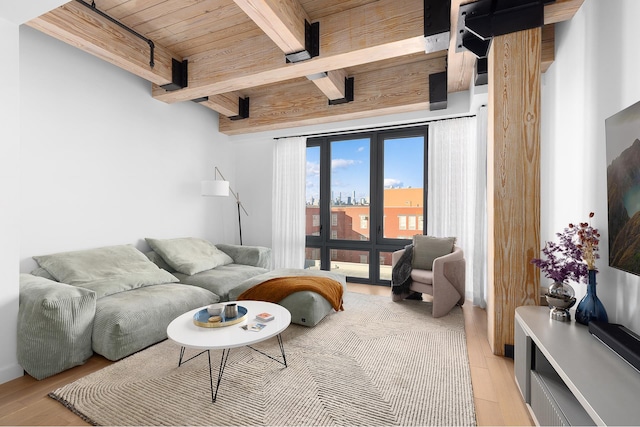 living room with wood ceiling, light wood finished floors, and beam ceiling