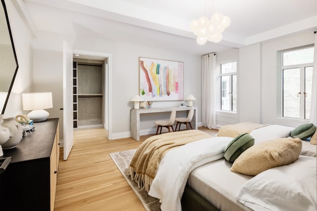 bedroom featuring hardwood / wood-style flooring and a chandelier