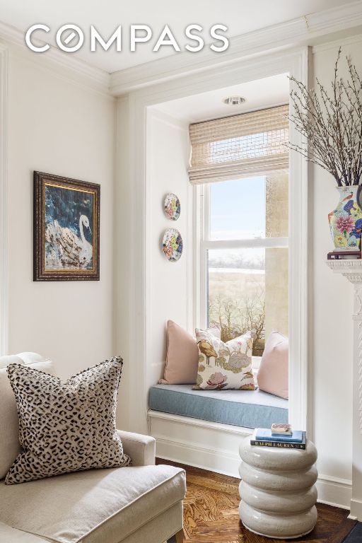 sitting room featuring crown molding and wood-type flooring